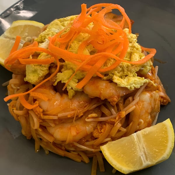 Golden Phoenix Chinese Restaurant's shrimp pad thai with shredded carrots, scrambled egg, and lemon wedges.