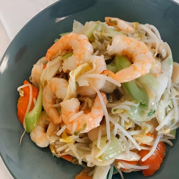 Golden Phoenix Chinese Restaurant's shrimp chow mein with vegetables and bean sprouts in a blue bowl.