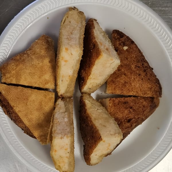 Golden Phoenix Chinese Restaurant's shrimp toast, cut into triangles, arranged on a white plate.